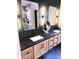Updated bathroom features double sinks, stylish light fixtures, and dark countertops at 3862 Cornwallis Ln, Carmel, IN 46032