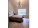 Bedroom with a modern light fixture, queen sized bed, and bright natural light at 3862 Cornwallis Ln, Carmel, IN 46032