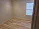 Simple bedroom with laminate floor and a window at 3862 Cornwallis Ln, Carmel, IN 46032