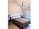 Bright bedroom with a modern light fixture and neutral decor exudes simple elegance at 3862 Cornwallis Ln, Carmel, IN 46032