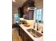 A view of a modern kitchen with stainless steel appliances, dark wood cabinets, and white granite countertops at 3862 Cornwallis Ln, Carmel, IN 46032