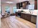 A stylish kitchen featuring stainless steel appliances, granite countertops, dark cabinets and modern lighting at 3862 Cornwallis Ln, Carmel, IN 46032