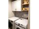 Laundry room showcases modern appliances, tile backsplash, and wooden shelving at 3862 Cornwallis Ln, Carmel, IN 46032