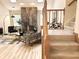 The living room includes a stone fireplace and a view of the staircase, with neutral décor at 3862 Cornwallis Ln, Carmel, IN 46032
