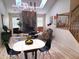 An open-concept living room with hardwood floors, a fireplace, and a staircase with wood railing at 3862 Cornwallis Ln, Carmel, IN 46032