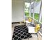 Cozy screened porch featuring comfortable seating, a stylish rug, and a view of the surrounding greenery at 3862 Cornwallis Ln, Carmel, IN 46032