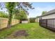 Fenced backyard featuring a shed and a deck with green grass at 3926 Rosefinch Cir, Indianapolis, IN 46228
