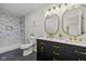 Updated bathroom featuring double sinks with gold fixtures and a shower with modern tile at 3926 Rosefinch Cir, Indianapolis, IN 46228