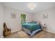 Bright bedroom with hardwood floors, a window, and a bed with teal comforter at 3926 Rosefinch Cir, Indianapolis, IN 46228