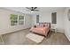Bright bedroom featuring a ceiling fan, light hardwood floors, and warm neutral walls at 3926 Rosefinch Cir, Indianapolis, IN 46228