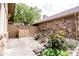 Charming backyard with stone accents, a wooden fence, flowers, and lush green foliage at 3935 Offshore Dr, Columbus, IN 47203