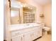 White bathroom vanity and sink with a large mirror and ample storage, with beige walls at 3935 Offshore Dr, Columbus, IN 47203