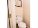 Powder room featuring toilet, tissue box, and framed needlepoint on peach colored walls at 3935 Offshore Dr, Columbus, IN 47203