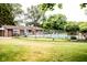 Community pool surrounded by lush greenery, a brick bathhouse, and black fencing at 3935 Offshore Dr, Columbus, IN 47203