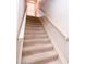 Carpeted stairway with painted wood railing, leading to an open doorway at the top at 3935 Offshore Dr, Columbus, IN 47203