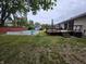 Poolside backyard with deck, outdoor seating, storage shed, mature trees, and lush green lawn at 404 E Madison St, Alexandria, IN 46001