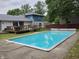 Backyard with inground swimming pool and deck, offering a relaxing outdoor space at 404 E Madison St, Alexandria, IN 46001
