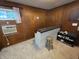Wood paneled basement featuring carpet, a window AC unit, and a bar at 404 E Madison St, Alexandria, IN 46001