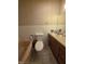 Cozy bathroom features a tub, toilet and vanity with oak colored cabinets at 404 E Madison St, Alexandria, IN 46001