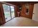 Wood paneled bedroom with carpet, sliding door, and view of the outdoor pool at 404 E Madison St, Alexandria, IN 46001