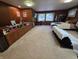 Well-lit bedroom with wood paneled walls, a bed, and built-in storage at 404 E Madison St, Alexandria, IN 46001