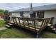Wooden deck with chairs, table, and an umbrella, perfect for outdoor entertaining and relaxation at 404 E Madison St, Alexandria, IN 46001