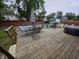 Large wooden deck with dining and lounging area overlooking the swimming pool at 404 E Madison St, Alexandria, IN 46001