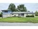 Charming brick home with a two-car garage, well-maintained lawn, and beautiful landscaping at 404 E Madison St, Alexandria, IN 46001