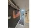 Hallway with dark gray walls, decorated with a wooden flag and wall art at 404 E Madison St, Alexandria, IN 46001