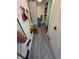 Narrow hallway with storage, laundry, and cleaning supplies at 404 E Madison St, Alexandria, IN 46001