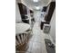 Eat in kitchen with dark cabinets, white table with chairs, and modern appliances at 404 E Madison St, Alexandria, IN 46001
