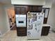 Kitchen featuring dark wood cabinets and white appliances, including a refrigerator and oven at 404 E Madison St, Alexandria, IN 46001