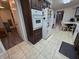 Well-lit kitchen with tile floors, dark cabinets, and stainless steel appliances at 404 E Madison St, Alexandria, IN 46001