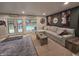 Comfortable living room with gray sectional sofa, and a view of the outdoor pool at 404 E Madison St, Alexandria, IN 46001