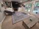Cozy living room featuring carpeted floors, built in shelving, and a large decorative rug at 404 E Madison St, Alexandria, IN 46001