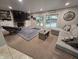 Spacious living room featuring a fireplace, large tv, and sliding doors to the outdoor pool area at 404 E Madison St, Alexandria, IN 46001