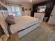 Bright bedroom with carpeted floors, dresser, and a white bed frame at 404 E Madison St, Alexandria, IN 46001