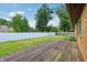 Spacious backyard featuring a deck, fencing, and beautiful shade trees at 410 E Southport Rd, Indianapolis, IN 46227
