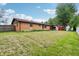 Spacious backyard featuring a brick house, lawn and shed at 410 E Southport Rd, Indianapolis, IN 46227