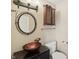 Bathroom featuring a unique sink, decorative mirror and cabinet at 410 E Southport Rd, Indianapolis, IN 46227