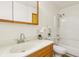 Cozy bathroom featuring a vanity, toilet, shower and floral decor at 410 E Southport Rd, Indianapolis, IN 46227