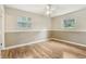 Bedroom featuring hardwood floors, neutral paint colors, and two windows at 410 E Southport Rd, Indianapolis, IN 46227
