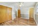 Spacious bedroom features a ceiling fan, hardwood floors, and closet at 410 E Southport Rd, Indianapolis, IN 46227