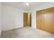 Bright bedroom with neutral walls, carpet, ceiling fan, and a closet at 410 E Southport Rd, Indianapolis, IN 46227