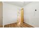 Neutral bedroom showing hardwood floors and an open door frame at 410 E Southport Rd, Indianapolis, IN 46227