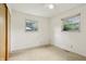 This bedroom has neutral walls and carpet, a ceiling fan, and a window at 410 E Southport Rd, Indianapolis, IN 46227