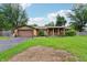 Charming single-story brick home with a well-maintained front lawn and covered porch at 410 E Southport Rd, Indianapolis, IN 46227