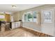 Bright kitchen area with a breakfast bar and a door leading to the outside at 410 E Southport Rd, Indianapolis, IN 46227