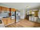 Open kitchen with stainless steel appliances and wood cabinetry at 410 E Southport Rd, Indianapolis, IN 46227