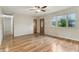 Bright living room with hardwood floors, ceiling fan, and natural light from a large window at 410 E Southport Rd, Indianapolis, IN 46227